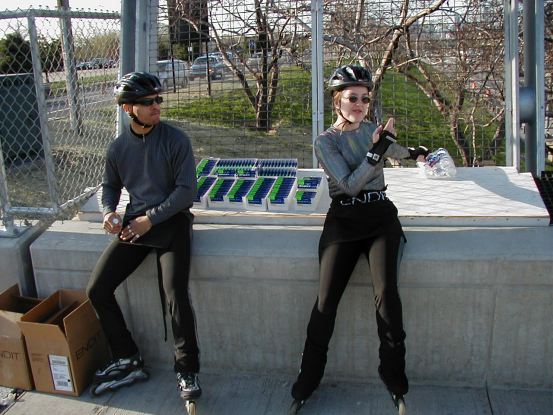 Joanna telling a motorist how he can use the water bottle she's reaching for.
