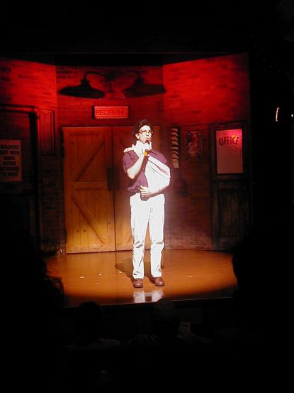 but has one drink too many as he's up on stage reliving his harrowing racing career. Luckily he was thinking enough to put on a toupee and glasses before going on stage.